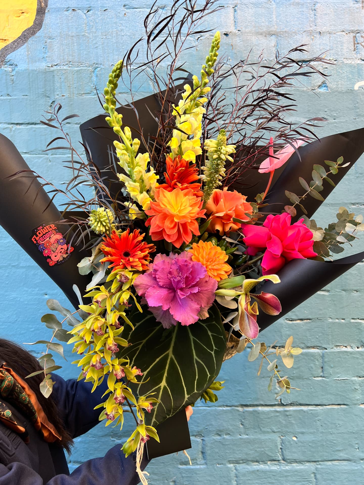 A hand-tied bouquet in The Flower Room's signature black wrap